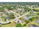 A yellow single-Gathering home with solar panels and screened in pool in a residential neighborhood is shown in an aerial view at 2940 Se 23Rd Ave, Ocala, FL 34471