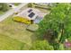 Aerial view of a yellow single-Gathering home with solar panels, a screened-in pool, and a fenced backyard at 2940 Se 23Rd Ave, Ocala, FL 34471