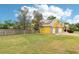 View of the backyard and side of the home with the two-car garage and fenced perimeter at 2940 Se 23Rd Ave, Ocala, FL 34471