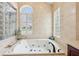 Large bathroom with a jacuzzi tub, tile surround, and decorative tile accents at 2940 Se 23Rd Ave, Ocala, FL 34471