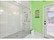 Bright bathroom featuring a spacious tiled shower with glass enclosure, door to outside and colorful decor at 2940 Se 23Rd Ave, Ocala, FL 34471