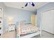 Cozy bedroom with a decorative bedspread, light blue walls, and a bright ceiling fan at 2940 Se 23Rd Ave, Ocala, FL 34471