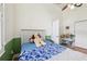 Cozy bedroom featuring a ceiling fan, wood floors, and a playful stuffed animal at 2940 Se 23Rd Ave, Ocala, FL 34471