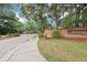Brick entrance to the Avondale community, featuring mature trees, greenery, and an elegant brick sign at 2940 Se 23Rd Ave, Ocala, FL 34471