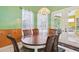 Cozy dining area featuring wood paneling and view to the backyard at 2940 Se 23Rd Ave, Ocala, FL 34471