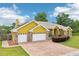 A charming single-Gathering home with a three-car garage, well-manicured lawn and brick-paved driveway at 2940 Se 23Rd Ave, Ocala, FL 34471