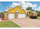 Charming single-story home with a two-car garage, brick accents and long brick driveway at 2940 Se 23Rd Ave, Ocala, FL 34471