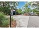 A secure gated entrance to a community, with brick pillars, mature trees and shrubs at 2940 Se 23Rd Ave, Ocala, FL 34471