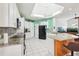 Spacious kitchen featuring white cabinets, granite counters, island with bar stools, and a skylight at 2940 Se 23Rd Ave, Ocala, FL 34471