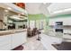 Bright kitchen with white cabinetry, granite countertops, and a skylight for natural lighting at 2940 Se 23Rd Ave, Ocala, FL 34471