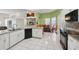 Bright kitchen with white cabinets, tile floor, and an island with bar seating at 2940 Se 23Rd Ave, Ocala, FL 34471