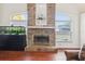 Open-concept living room featuring brick fireplace, aquarium, and large windows at 2940 Se 23Rd Ave, Ocala, FL 34471