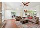 Bright living room boasts wood floors and opens to an office and the kitchen at 2940 Se 23Rd Ave, Ocala, FL 34471