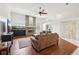 Spacious living room features a brick fireplace and modern ceiling fan at 2940 Se 23Rd Ave, Ocala, FL 34471