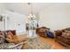 Spacious living room featuring wood floors, a chandelier, and elegant furnishings at 2940 Se 23Rd Ave, Ocala, FL 34471