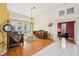 Living room showcasing elegant furnishings, wood floors, and tall windows with backyard views at 2940 Se 23Rd Ave, Ocala, FL 34471