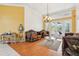 Living room with elegant furnishings, wood floors, tall windows with backyard views, and chandelier at 2940 Se 23Rd Ave, Ocala, FL 34471