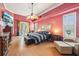 Spacious main bedroom with a sitting area, wood floors, a ceiling fan, and French doors at 2940 Se 23Rd Ave, Ocala, FL 34471