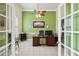 Home office with green walls, white tile flooring, and a ceiling fan at 2940 Se 23Rd Ave, Ocala, FL 34471