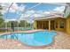 Beautiful backyard pool with screened enclosure, manicured backyard and brick paver pool deck for luxurious outdoor living at 2940 Se 23Rd Ave, Ocala, FL 34471