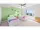 Bright bedroom featuring two twin beds, ceiling fan, and a window with a view at 2967 S Atlantic Ave # 1601, Daytona Beach Shores, FL 32118