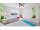 Bright bedroom with two twin beds, ceiling fan, a window with a view, and a closet at 2967 S Atlantic Ave # 1601, Daytona Beach Shores, FL 32118