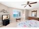 Bedroom with a king-size bed, TV, ceiling fan, and a window with a view at 2967 S Atlantic Ave # 1601, Daytona Beach Shores, FL 32118
