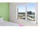 Bright bedroom with large window offering a beautiful cityscape view at 2967 S Atlantic Ave # 1601, Daytona Beach Shores, FL 32118