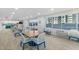 Airy dining area with multiple tables, chairs, large windows, and natural light at 2967 S Atlantic Ave # 1601, Daytona Beach Shores, FL 32118