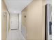 Inviting hallway with neutral tones, white doors, tile flooring, and stainless-steel refrigerator, enhancing the home's appeal at 2967 S Atlantic Ave # 1601, Daytona Beach Shores, FL 32118