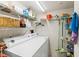 Functional laundry room featuring a washer, dryer, and shelving, optimizing storage and convenience for household chores at 2967 S Atlantic Ave # 1601, Daytona Beach Shores, FL 32118