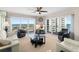 Bright living room featuring floor-to-ceiling windows with stunning waterfront views and elegant furnishings at 2967 S Atlantic Ave # 1601, Daytona Beach Shores, FL 32118