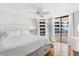 Bright bedroom with a ceiling fan, tiled floors, and a sliding glass door to the outside balcony at 3023 S Atlantic Ave # 4020, Daytona Beach, FL 32118