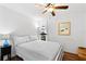 Cozy bedroom featuring a ceiling fan, wood floors, and a bright window, creating a tranquil space at 3023 S Atlantic Ave # 4020, Daytona Beach, FL 32118