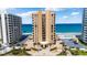 Stunning oceanfront condo building with multiple floors, palm trees, and ample parking spaces at 3023 S Atlantic Ave # 4020, Daytona Beach, FL 32118