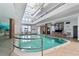 Inviting indoor pool area featuring ample lighting and stylish architectural design in a condominium complex at 3023 S Atlantic Ave # 4020, Daytona Beach, FL 32118