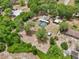 Aerial view of property featuring screened pool, sheds, and canopy surrounded by mature trees at 31544 Wekiva River Trl, Sorrento, FL 32776
