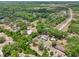 Aerial shot showcases the property and neighborhood, surrounded by greenery, and a highway nearby at 31544 Wekiva River Trl, Sorrento, FL 32776