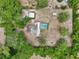 Bird's-eye view showing mature trees, sheds, canopies, and screened-in pool in backyard at 31544 Wekiva River Trl, Sorrento, FL 32776