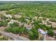 Aerial view of residences surrounded by mature trees, showing the generous spacing between properties at 31544 Wekiva River Trl, Sorrento, FL 32776