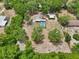Aerial view of home showcasing pool and a spacious, tree-filled yard, enclosed by fencing at 31544 Wekiva River Trl, Sorrento, FL 32776
