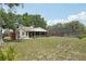 The backyard features the home, a pool with a screen, and lovely landscaping at 31544 Wekiva River Trl, Sorrento, FL 32776