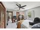 Bedroom with soft gray walls, carpet, ceiling fan, and closet space at 31544 Wekiva River Trl, Sorrento, FL 32776
