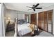 Bedroom featuring gray walls, carpet, ceiling fan and warm wooden trim at 31544 Wekiva River Trl, Sorrento, FL 32776