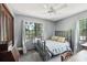 Bedroom with gray walls, carpet, ceiling fan and large, bright window at 31544 Wekiva River Trl, Sorrento, FL 32776