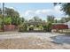 View of the metal carport and partial view of the fenced backyard and surrounding green space at 31544 Wekiva River Trl, Sorrento, FL 32776