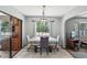 Bright dining room with large window, chandelier, and view of the living room at 31544 Wekiva River Trl, Sorrento, FL 32776