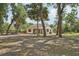 Cozy home nestled among mature trees, featuring a screened porch and spacious yard at 31544 Wekiva River Trl, Sorrento, FL 32776