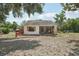 Charming single-story home featuring a cozy screened-in porch and colorful landscaping at 31544 Wekiva River Trl, Sorrento, FL 32776