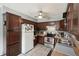 View of kitchen featuring brown cabinets, stainless steel appliances and light tile flooring at 31544 Wekiva River Trl, Sorrento, FL 32776